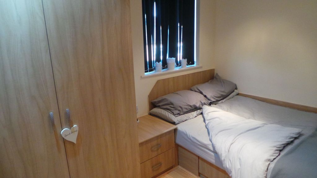 Property photo 3 of 6 A Cozy Double Bedroom With Neutral Bedding, A Wood...