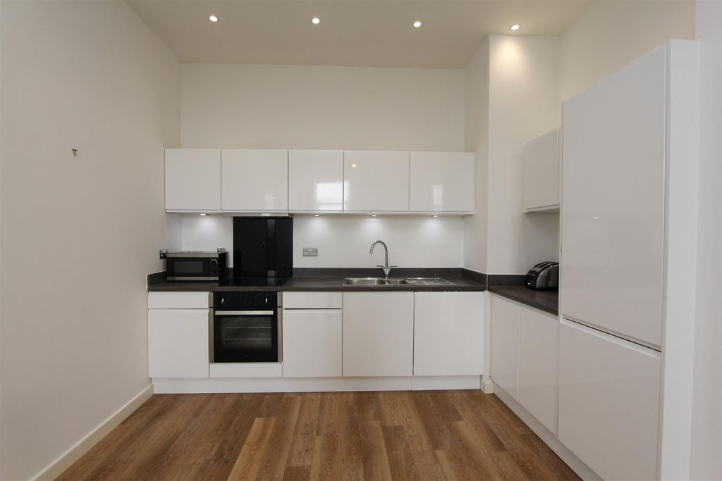 Property photo 2 of 11 Modern Kitchen With Sleek White Cabinetry...