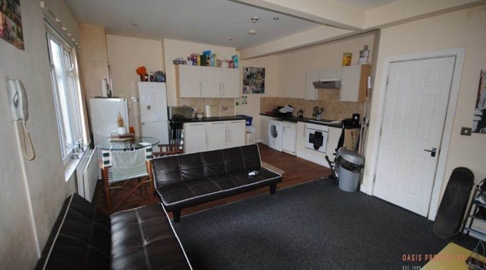 Property photo 2 of 8 A Modern, Well-Lit Living Room Featuring A Comfort...