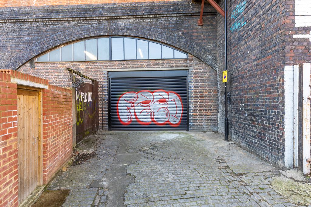 Property photo 2 of 10 The Front Of An Arch With A Closed Electric Roller Shutter Entrance Big Enough For Vehicle Access.