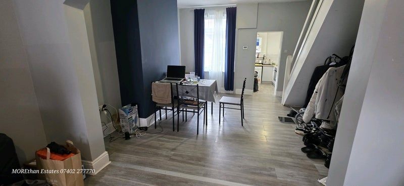 Property photo 2 of 7 A Bright And Modern Living Room Featuring Wood-Eff...