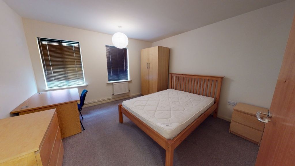 Property photo 1 of 7 Bright And Inviting Master Bedroom With A Wooden d...