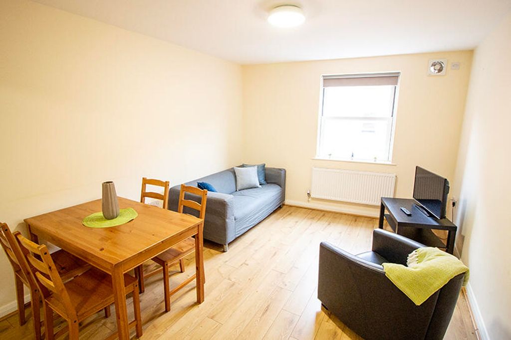 Property photo 2 of 5 Spacious Living Room Featuring A Cozy Sofa, Stylis...