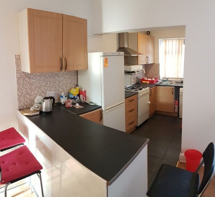 Property photo 2 of 6 Modern Galley-Style Kitchen With Light Wood Cabine...