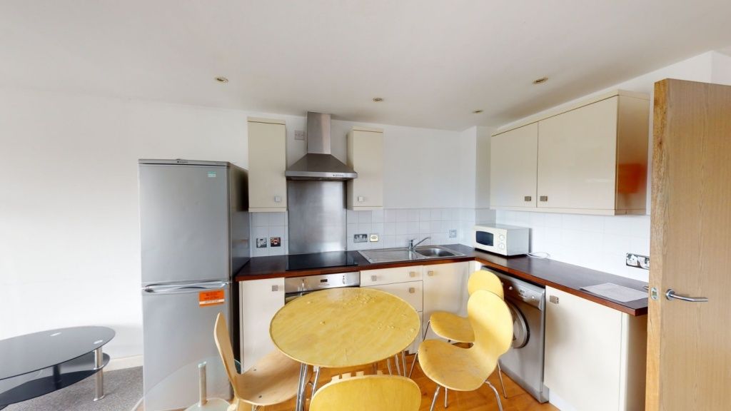 Property photo 3 of 6 Bright And Modern Kitchen Featuring White Cabinetr...