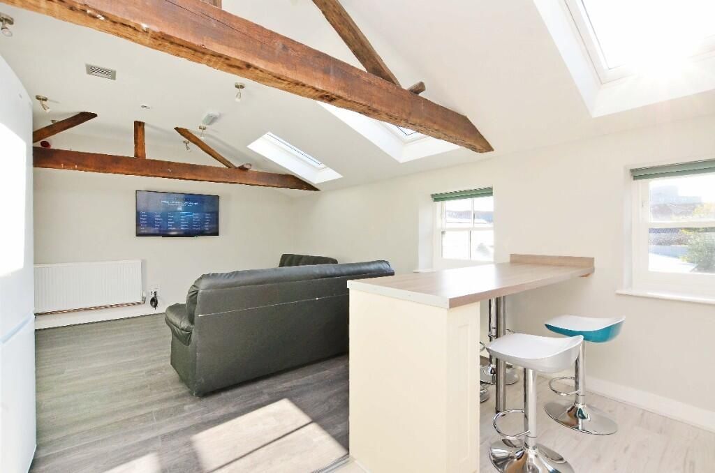 Property photo 3 of 9 Bright And Airy Living Space Featuring Exposed Woo...