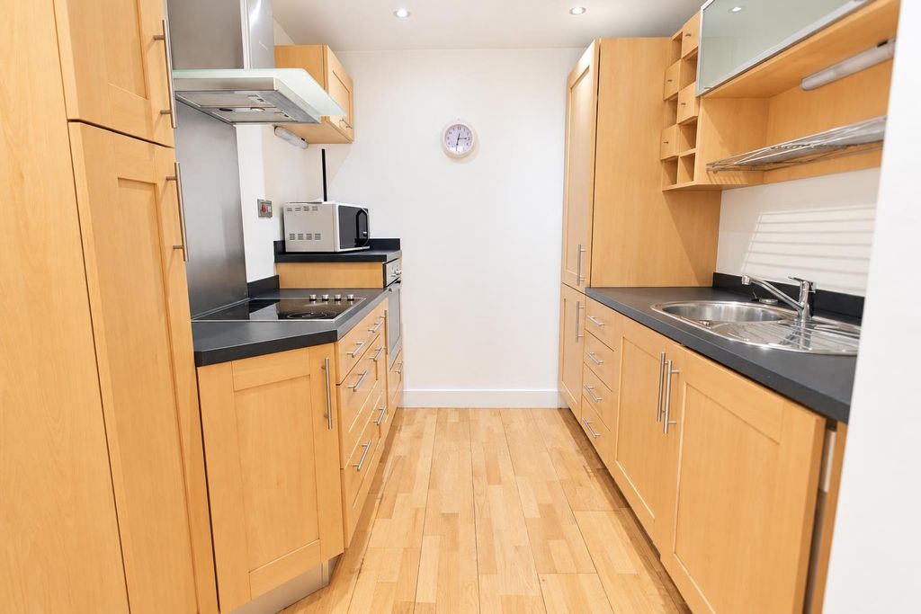 Property photo 3 of 8 Bright Modern Kitchen With Ample Storage Space...