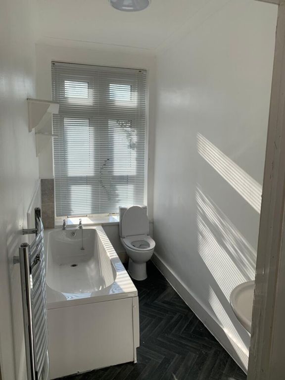 Property photo 3 of 6 Bright And Modern Bathroom Featuring A Stylish Bat...