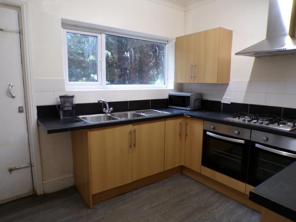 Property photo 3 of 10 This Inviting Kitchen Features Modern Cabinetry, A...