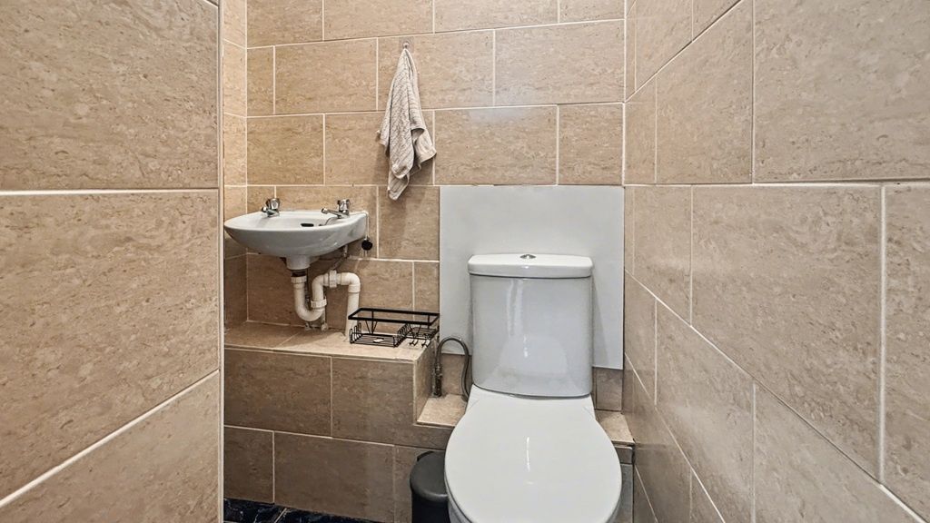 Property photo 1 of 9 Modern Tiled Washroom With Convenient Sink...