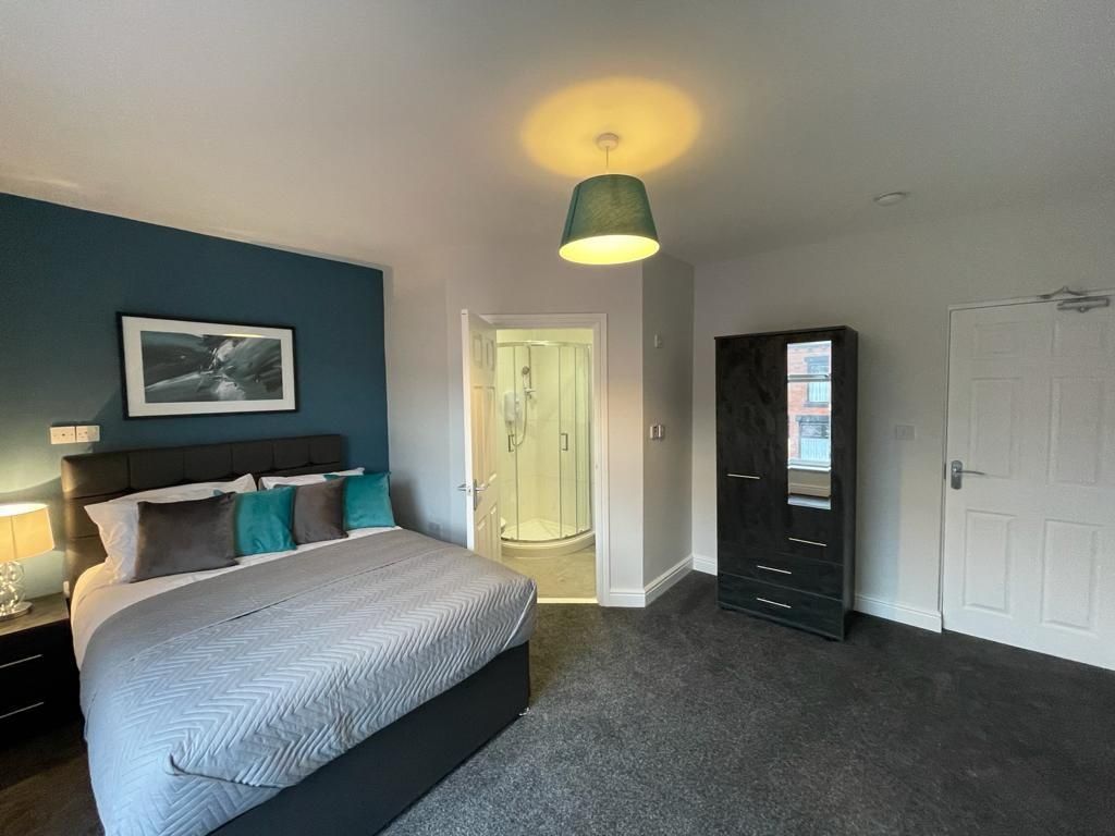 Property photo 1 of 12 A Stylish And Spacious Master Bedroom Featuring A ...