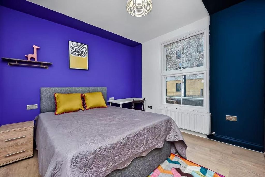 Property photo 1 of 25 A Bright And Modern Bedroom Featuring A Large Bed ...
