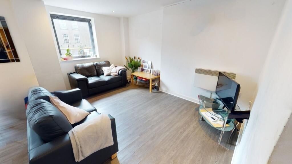 Property photo 3 of 6 A Bright And Welcoming Living Room Featuring Two c...
