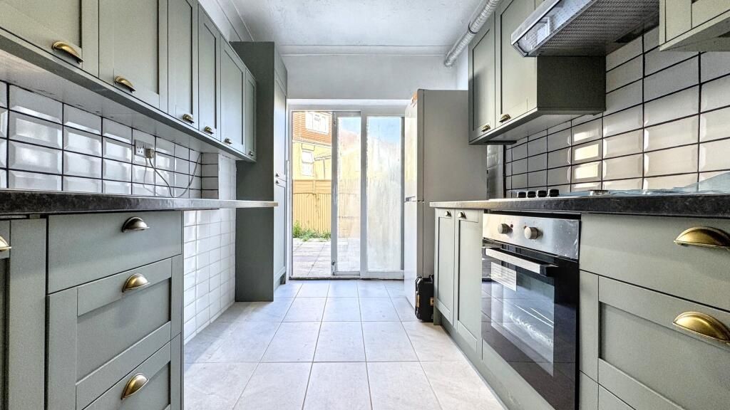 Property photo 3 of 13 Bright And Modern Kitchen Featuring Sleek Grey Cab...