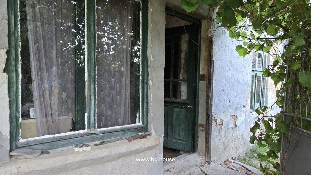 Property photo 1 of 29 View Of The House Entrance Showing A Green Wooden Door And Window With Lace Curtains On A Textured Plaster Wall.