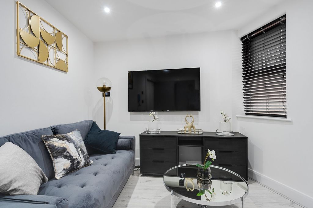 Property photo 2 of 5 Modern Living Room Featuring A Comfortable Grey So...