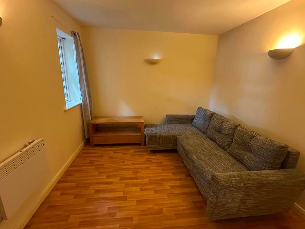 Property photo 3 of 6 A Cozy Living Room Featuring A Large Grey Sectiona...