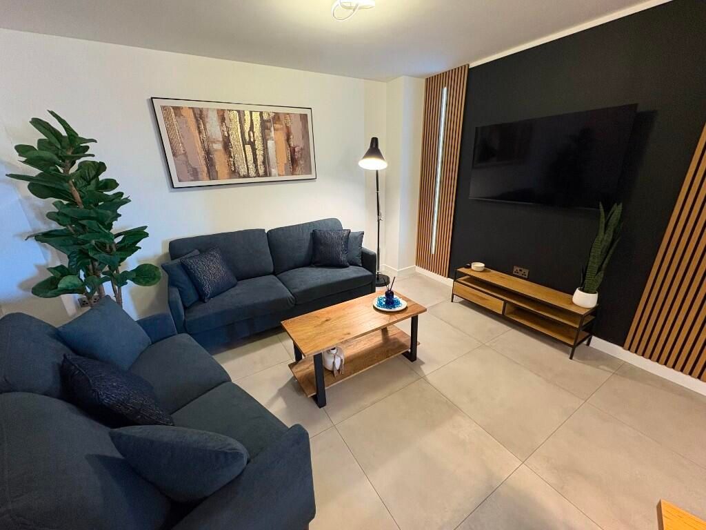 Property photo 1 of 12 A Contemporary Living Room Featuring Comfortable N...