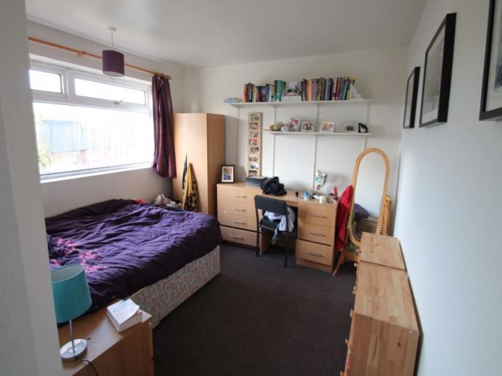 Property photo 2 of 6 A Cozy And Well-Lit Bedroom Featuring A Comfortabl...