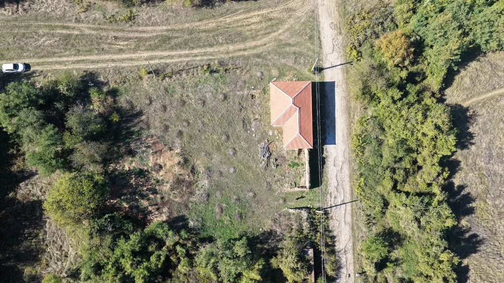 Property photo 1 of 28 Top-Down View Showing The House With A Red Tiled Roof, Grassy Land, Trees, And A Dirt Road With A White Car.