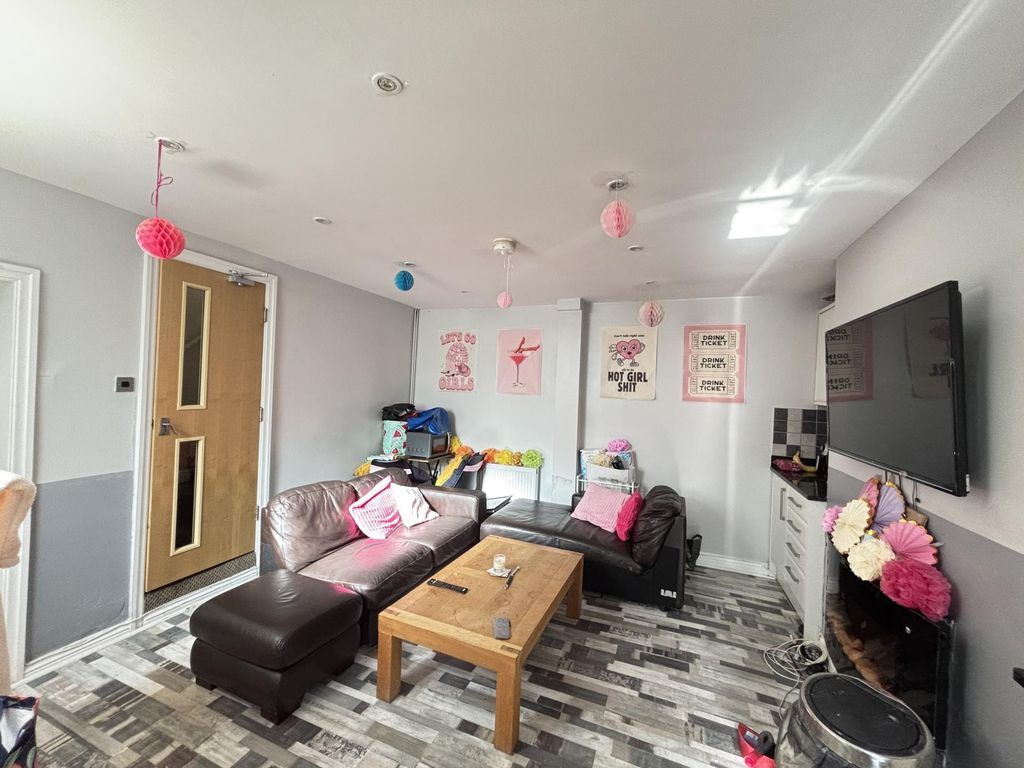 Property photo 1 of 18 A Bright And Modern Living Room Featuring A Large ...