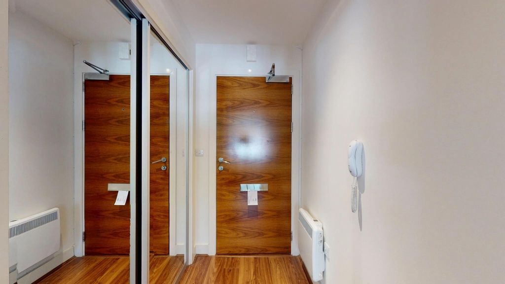 Property photo 2 of 14 A Clean And Modern Hallway Featuring Wood Laminate...