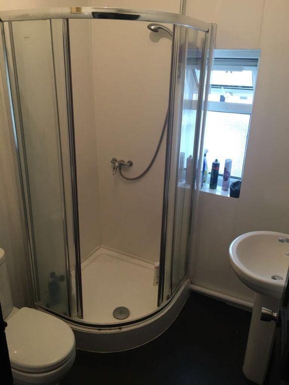 Property photo 3 of 12 This Modern Bathroom Features A Sleek Shower Enclo...