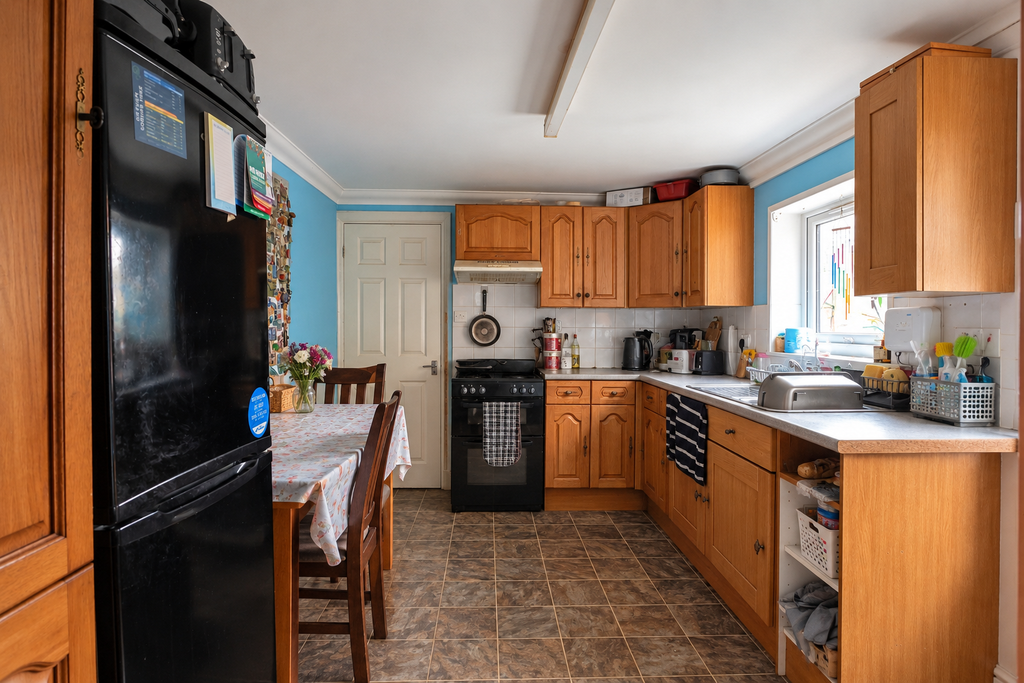 Property photo 3 of 16 Lived-In Galley Kitchen In Daylight