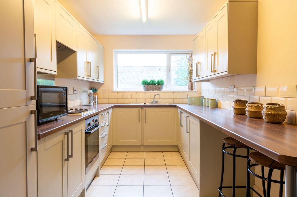 Property photo 1 of 10 Bright, Modern Galley Kitchen With Cream Cabinetry...