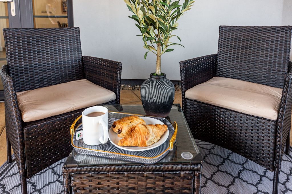 Property photo 2 of 7 Cozy Outdoor Seating Area Featuring Two Cushioned ...