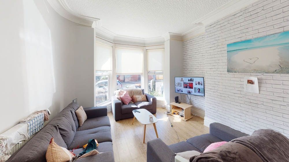 Property photo 1 of 8 Bright And Welcoming Living Room Featuring A Spaci...