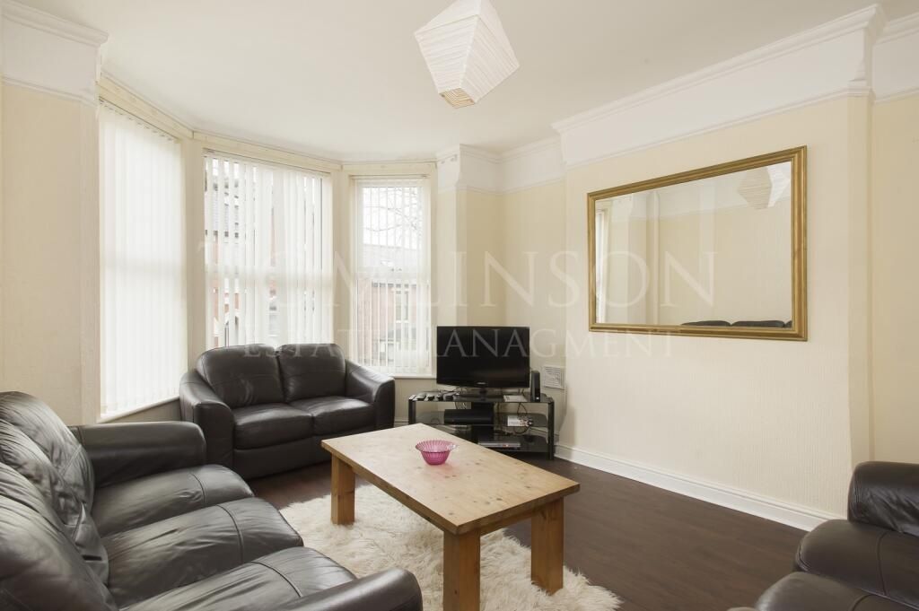 Property photo 2 of 11 A Bright And Inviting Living Room Featuring Comfor...