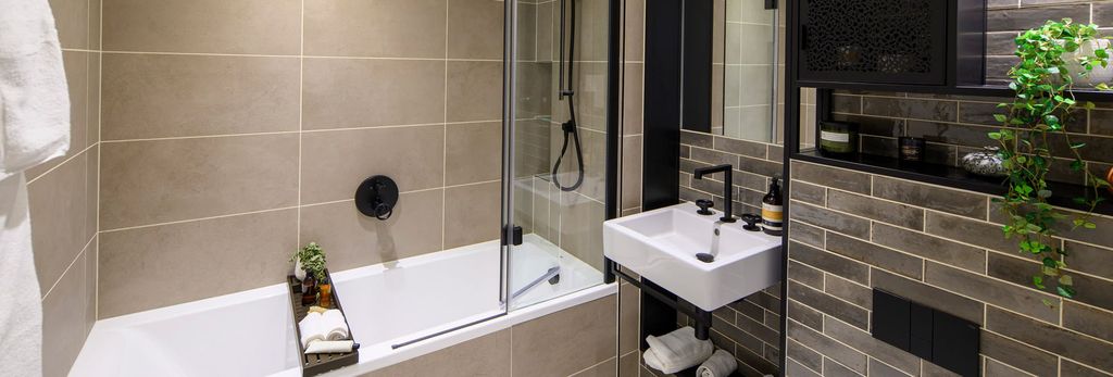 Property photo 3 of 5 Bathroom With Shower Over Bath, Light Brown Masonry Style Tiling, Wash Basin With Mirror And