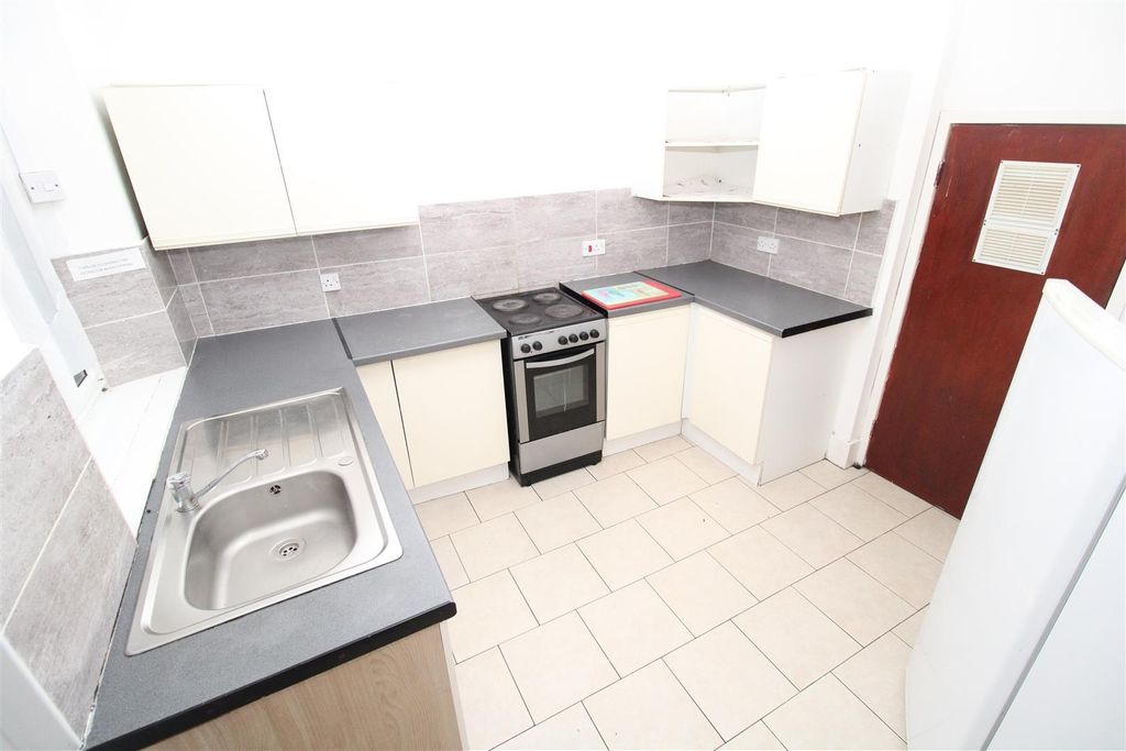 Property photo 3 of 4 Bright Kitchen With Ample Workspace And Storage...