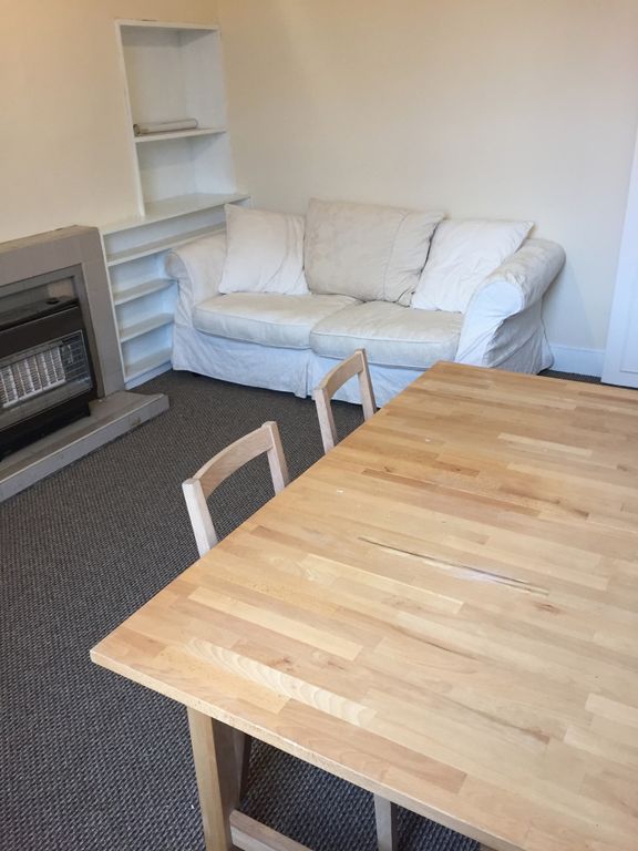 Property photo 2 of 9 A Cozy Living Room Featuring A Comfortable White S...