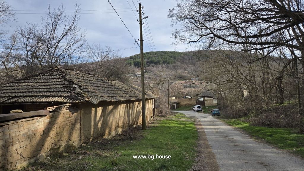 Property photo 3 of 53 Narrow Village Road Bordered By A Stone Wall And Leafless Trees, With A Hill And Scattered Houses In The Background