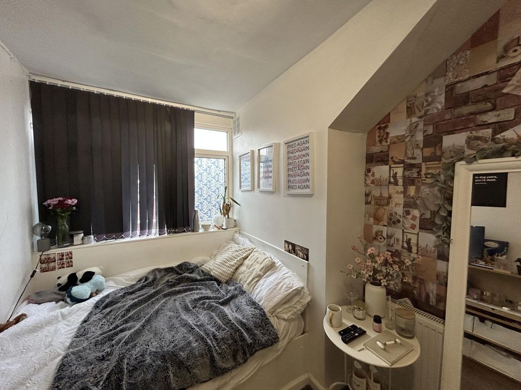 Property photo 2 of 18 A Cozy Bedroom Featuring A Large Window Dressed Wi...