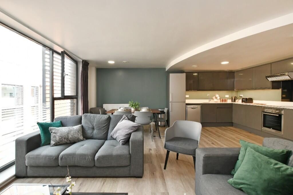 Property photo 3 of 11 Bright And Modern Living Room Featuring A Comforta...