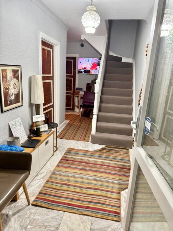 Property photo 3 of 7 Bright And Welcoming Entryway With Stylish Decor...