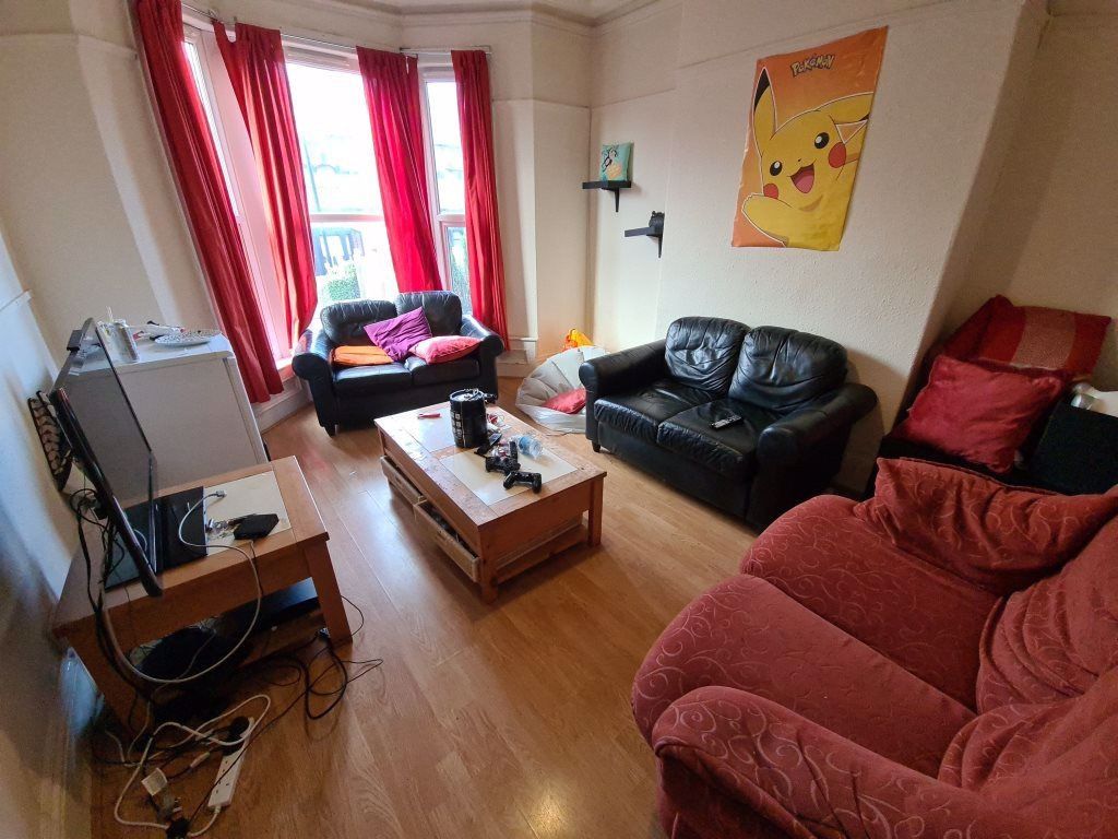 Property photo 1 of 11 A Cozy And Inviting Living Room Featuring A Combin...