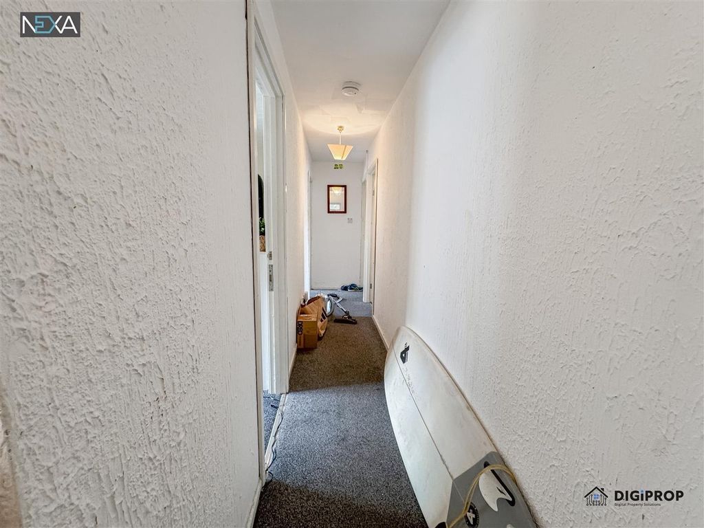 Property photo 2 of 15 A Long Hallway With Neutral White Walls....