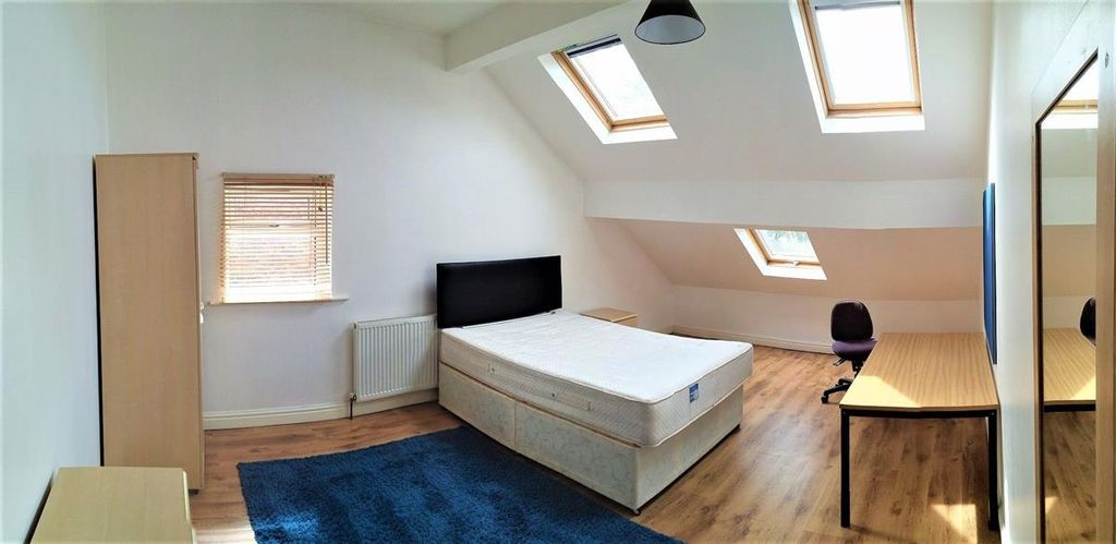 Property photo 2 of 12 Bright And Spacious Attic Bedroom Featuring A Comf...