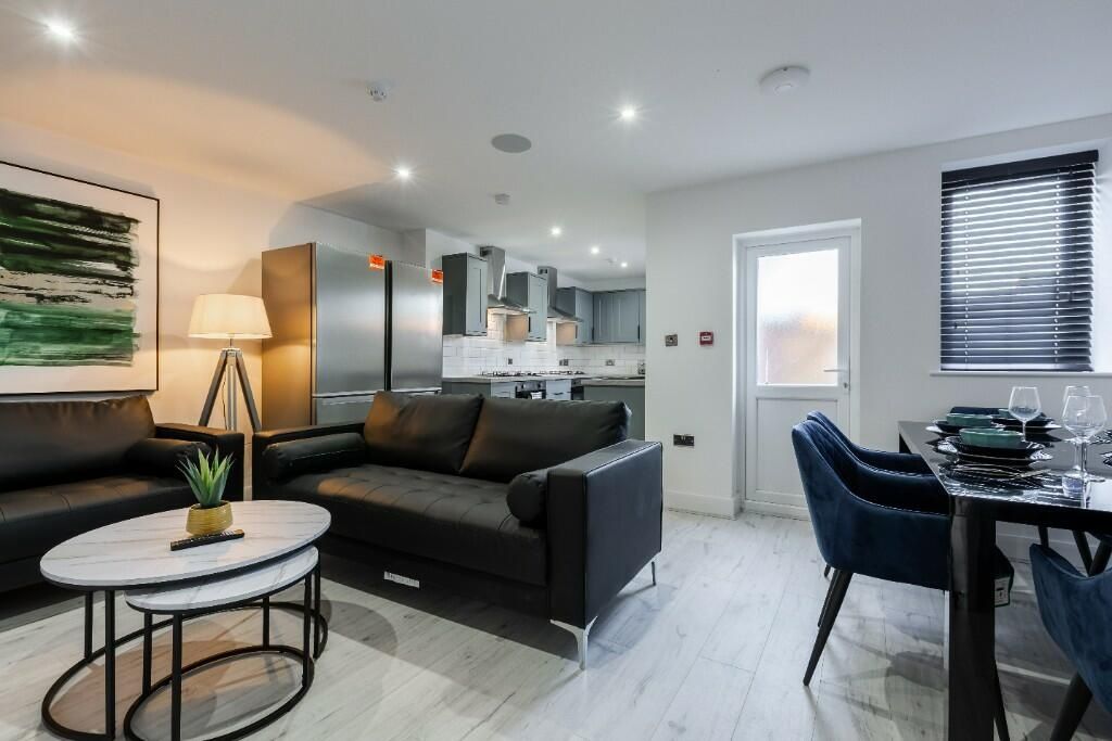 Property photo 3 of 15 A Modern, Well-Lit Living Room Featuring Comfortab...