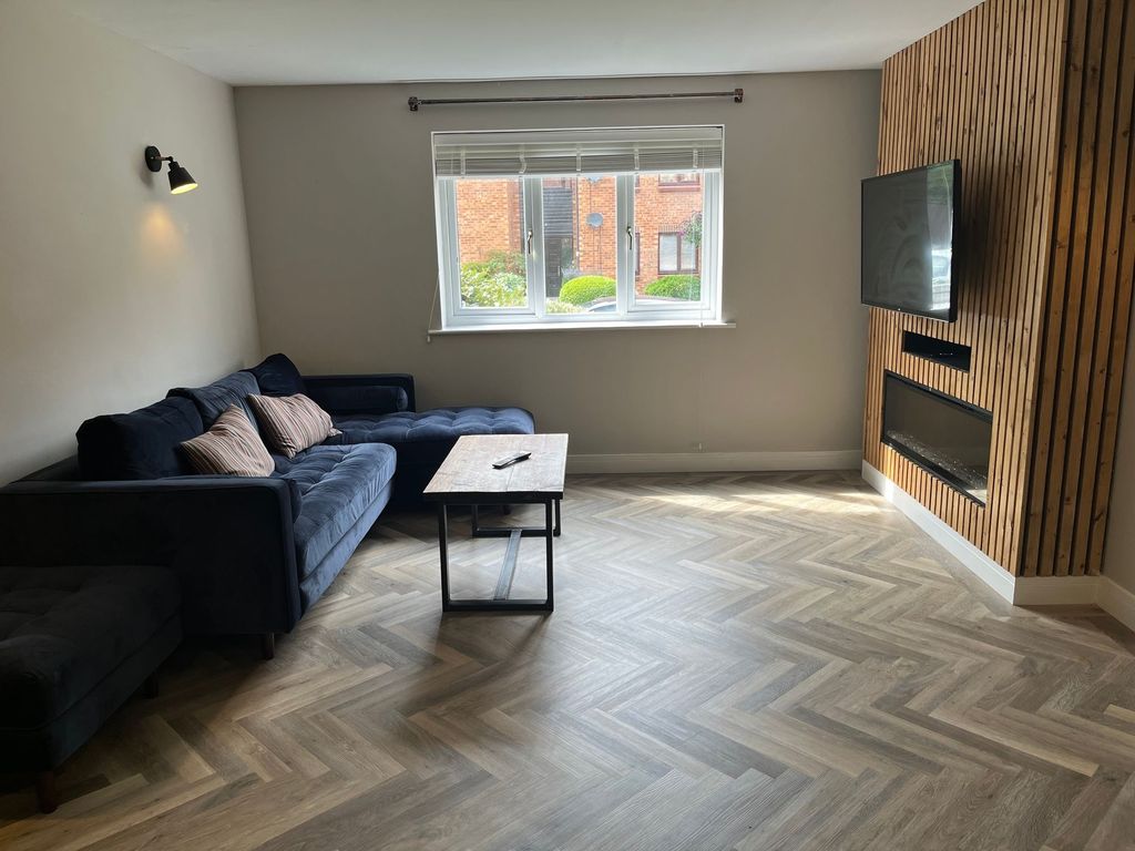 Property photo 3 of 6 A Modern And Tidy Living Room Featuring A Stylish ...