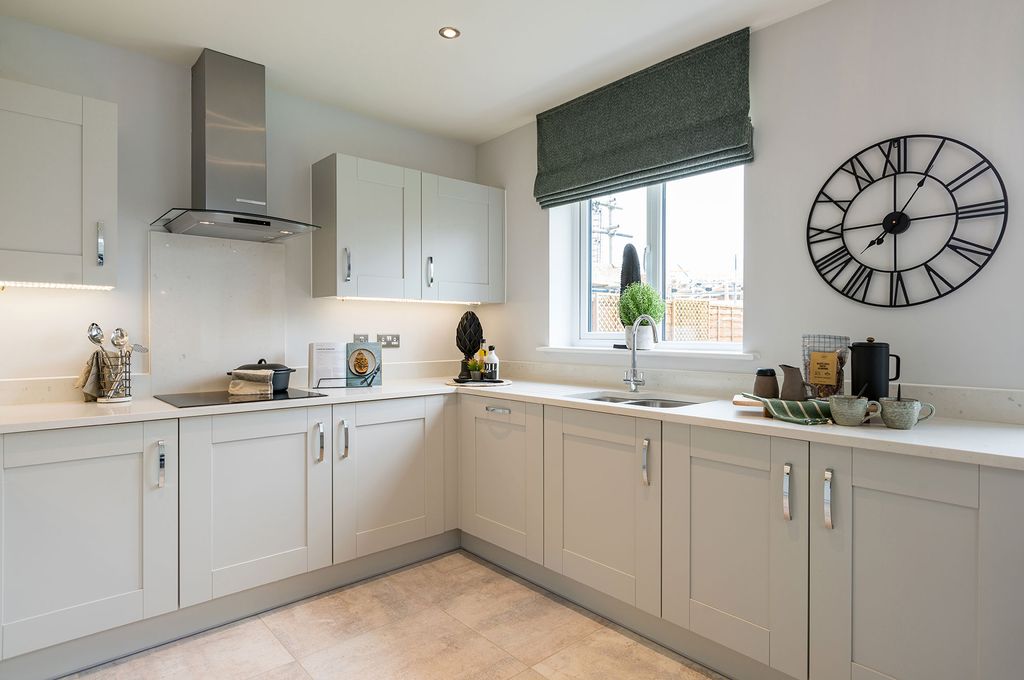 Property photo 2 of 7 A Modern, Light-Colored Kitchen With A Stainless Steel Range Hood And Cabinets In The Foreground