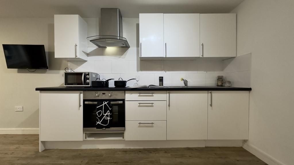 Property photo 3 of 6 A Modern And Well-Maintained Kitchen With Sleek Wh...