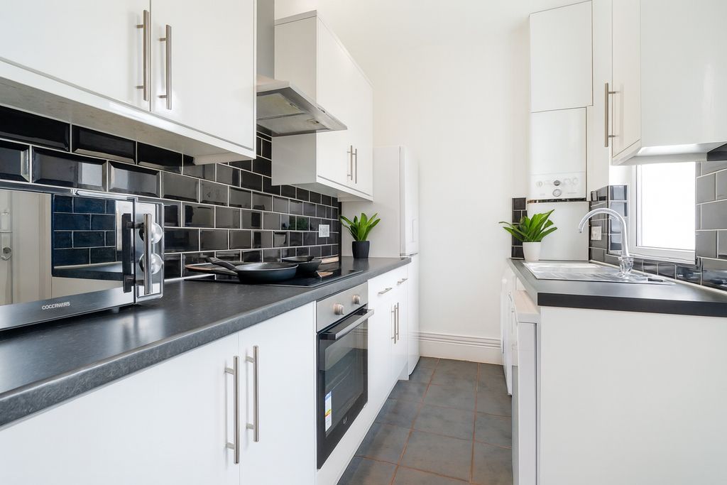 Property photo 1 of 5 Bright Modern Kitchen With Sleek Black Tiling...