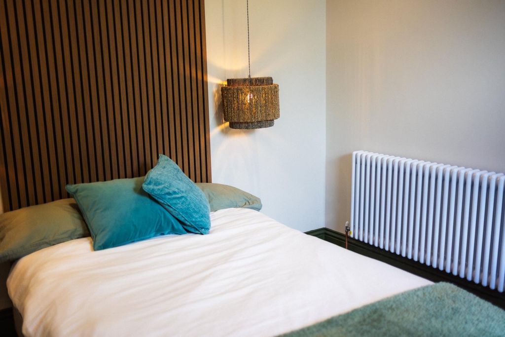 Property photo 1 of 12 A Cozy Double Bedroom Featuring A Stylish Wooden S...