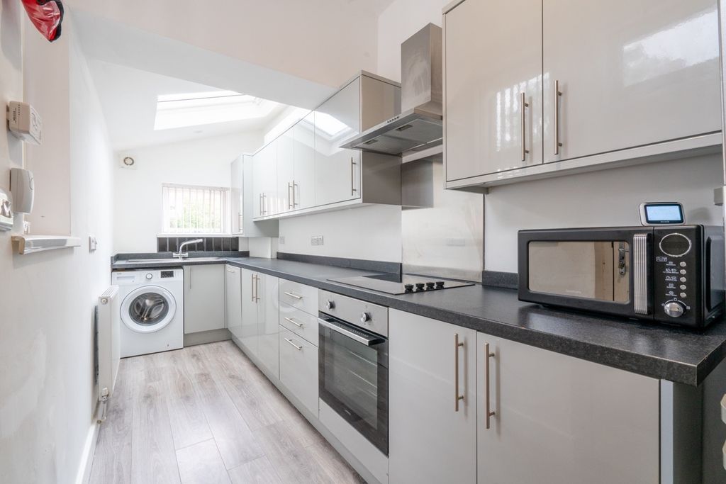 Property photo 1 of 6 Bright And Modern Kitchen Featuring Sleek Grey Cab...