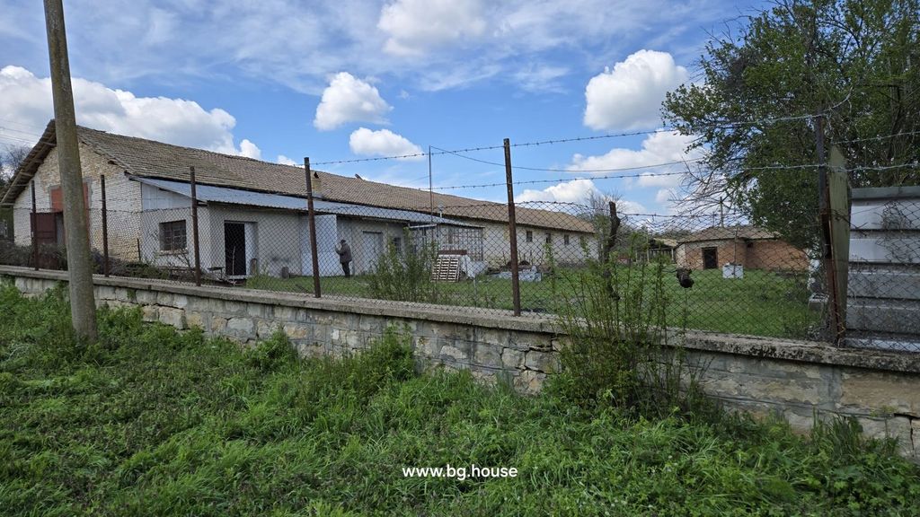 Property photo 3 of 100 View Of A Farm Building Enclosed By A Wire Fence, Showing A Man Standing Near The Entrance And Green Grass Outside